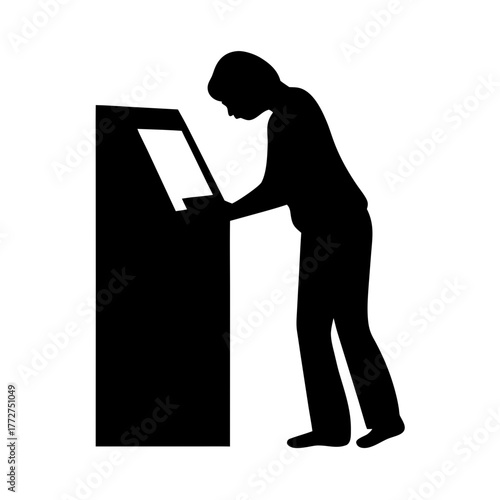 Person using interactive touchscreen kiosk silhouette