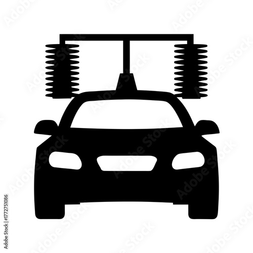 Car undergoing cleaning at automatic car wash silhouette