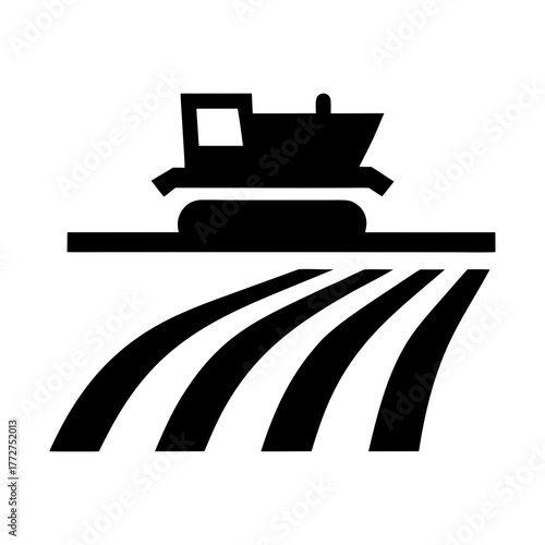 Agricultural combine harvester working on a field silhouette