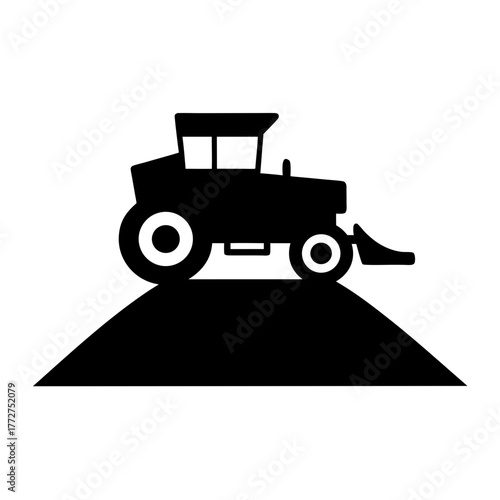 Tractor silhouette on a hill with a loader silhouette