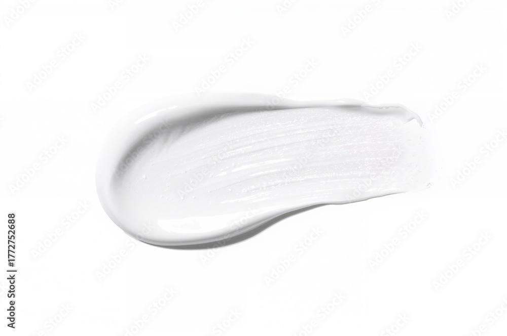 Fototapeta premium White cosmetic cream spread on a light surface. Texture of skincare product.