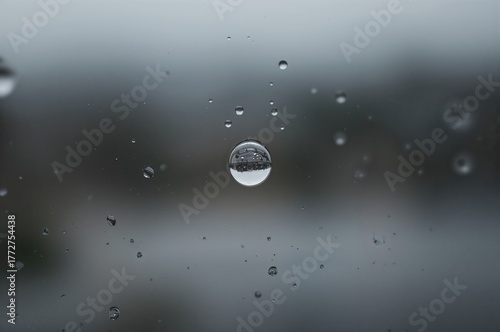 Water Droplet Clinging to Glass Pane