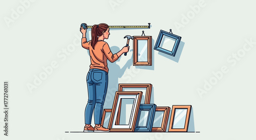 A woman hangs frames on the wall using a measuring tape and hammer, concept for home decoration, interior design and personal expression