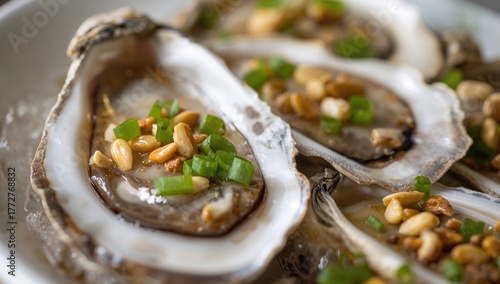 Opened oysters garnished wi...