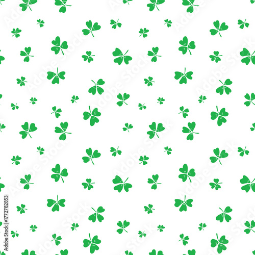 Green white shamrocks seamless vector pattern background. Tossed three leaf clover on white backdrop. Irish lucky charm motifs. Scattered St. Patricks day symbols for celebration background.