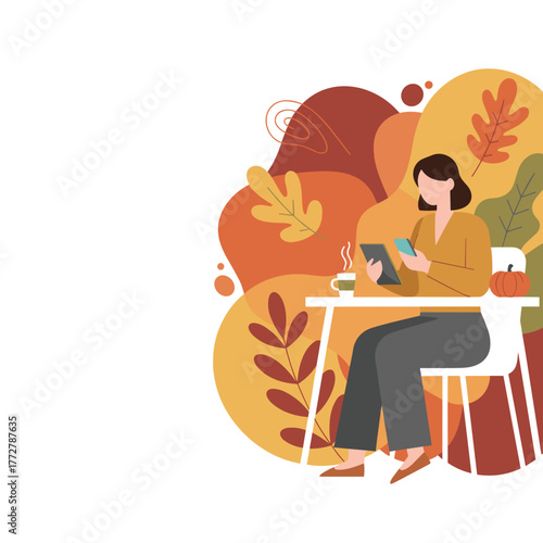 Woman using tablet in autumn setting enjoying cozy coffee break and fall colors
