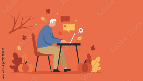 Senior man uses laptop for remote work and communication in a cozy seasonal autumn setting