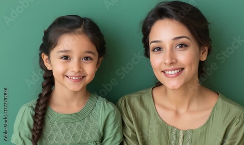 Close-up Portrait of an Indian Mom and Young Girl Posing in Green Outfits generative ai