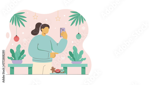 Girl taking a festive photo of gingerbread and holiday decorations with a smartphone