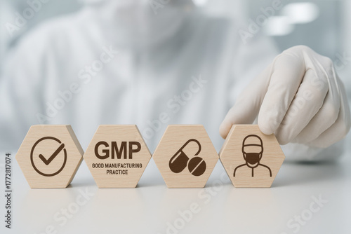 Focused scientist arranging wooden hexagons for GMP quality control. Pharmaceutical production standard concept with icons in sterile laboratory background showing focused compliance