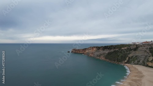 Beautiful coastline and city of Nazare, Portugal on a cloudy autumn day