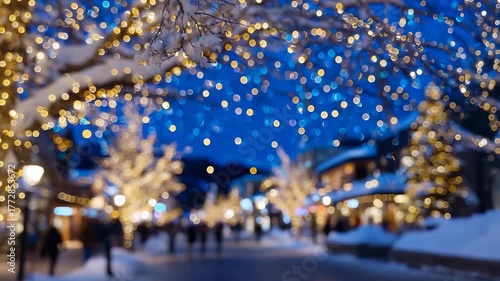 135Golden fairy lights strung on snow-covered tree branches, blurred silhouettes of people walking festive city street in background, space for text