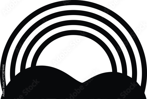Black silhouette of rainbow over rolling hills