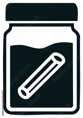 Cinnamon stick in a jar of liquid, illustrating spice infusion or food preservation