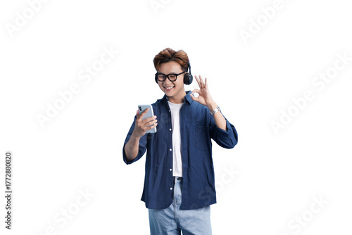 Music Enthusiast: An individual immersed in the world of music, donning headphones and holding a phone, radiating positive energy. He gives the okay gesture.
