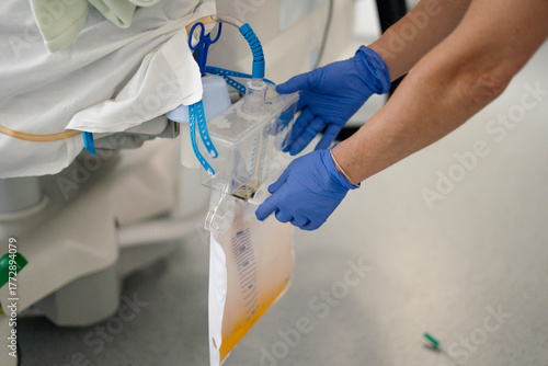 Nurse handling a urine drainage bag system