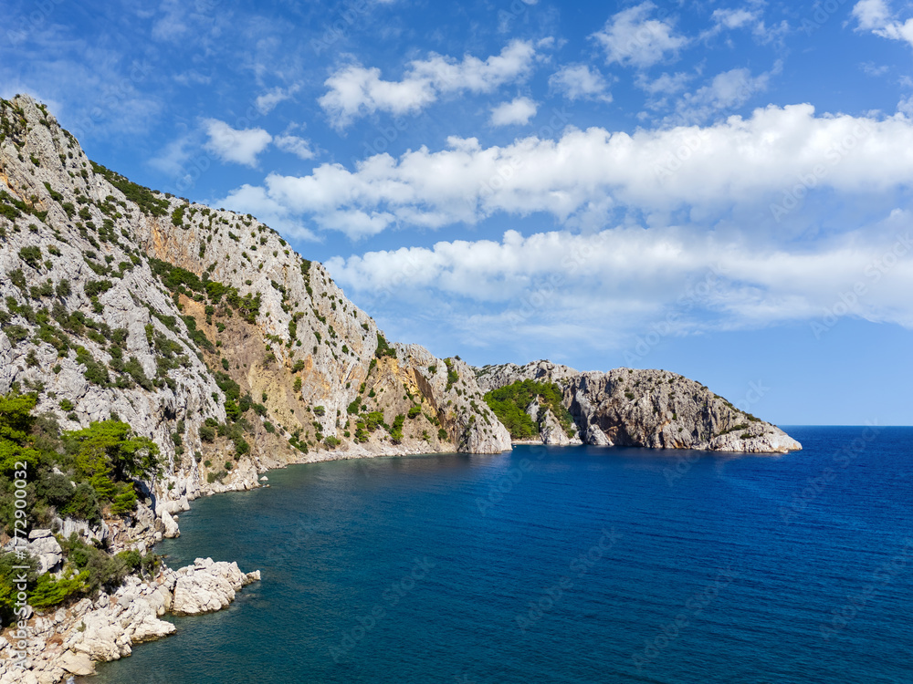 Fototapeta premium Antalya coastline with lush green plants on steep rocks