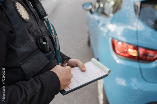 Foto Police officer writing a ticket for a parking violation