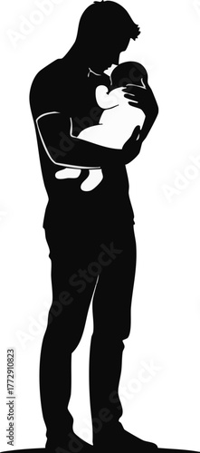 Silhouette of a father lovingly holding his newborn baby in his arms.