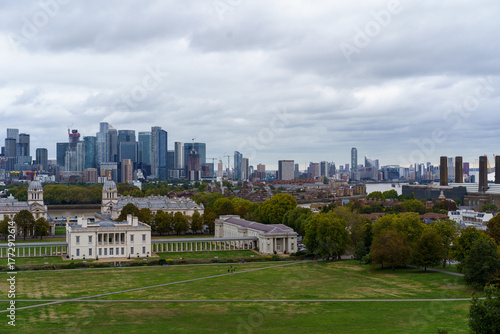 Photography Greenwich Park and Old Royal Naval College, with the River Thames and modern Canary Wharf skyline under an overcast London sky