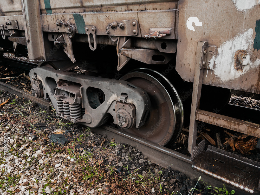 Naklejka premium A railway carriage that derailed on a sunny day. An accident on the railroad. Derailment of railway wagons. As a result of the train accident, the train derailed. A derailed carriage.