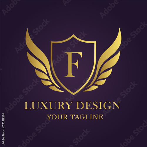 Golden letter f emblem with wings and luxury design text on a dark purple background