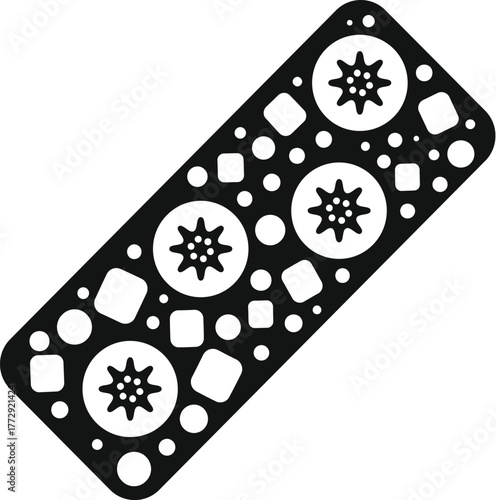 Close up of a black rectangular gasket, featuring various holes and star shapes, essential for engine maintenance and sealing