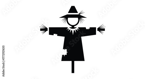 A classic black and white silhouette of a traditional scarecrow wearing a hat and tattered clothing standing in a field silhouette
