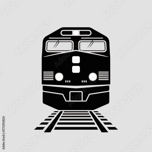 Front view of a black diesel locomotive on train tracks