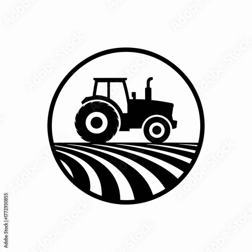 Black silhouette of a tractor on a plowed field within a circle