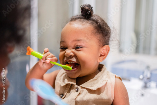 Mother and daughter brushing teeth together