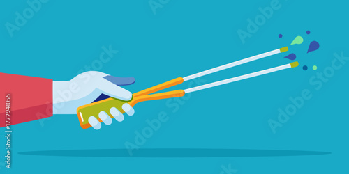 Hand holding trash tweezers with colorful waste particles flying  