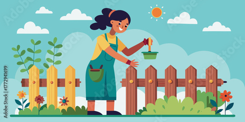 Young woman gardening and nurturing plants by wooden fence in spring  