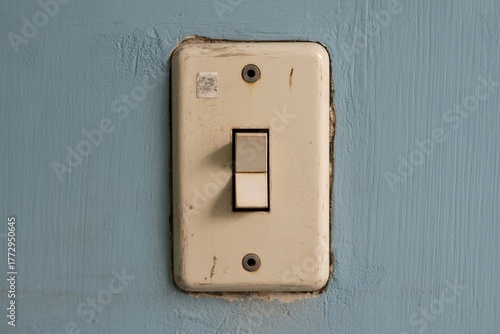 Close up of vintage light switch on blue wall for electrical home concept