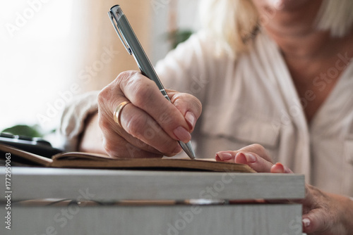 Photography Senior woman writing in notebook or journal