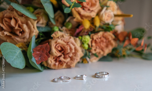Rings, earrings, bouquet, bridal shoe