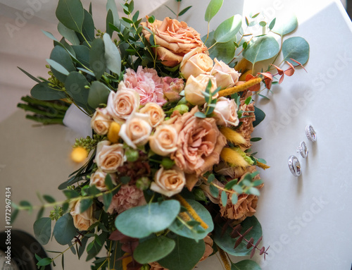 Rings, earrings, bouquet, bridal shoe