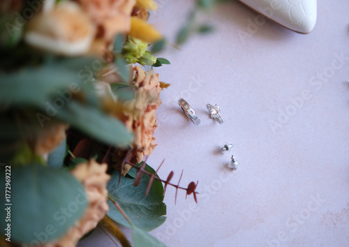 Rings, earrings, bouquet, bridal shoe