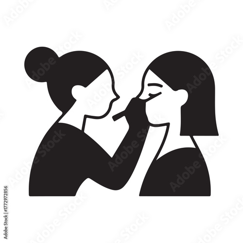 Makeup artist applying makeup to a woman s face with a brush
