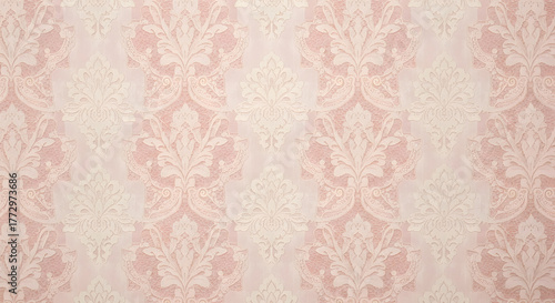 A light pink wallpaper with a floral damask pattern in a repeating symmetrical arrangement style