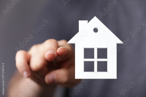 A person's hand pointing at...