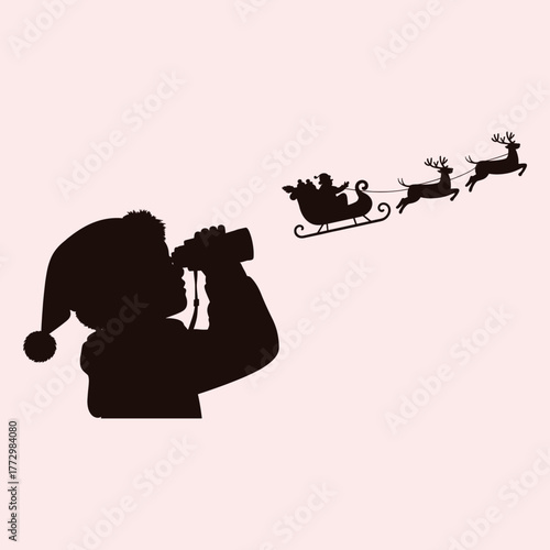 Silhouette of child wearing Santa hat looking through binoculars at Santa's sleigh pulled by reindeer