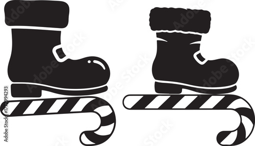 Two black santa boots resting on striped candy canes christmas icons