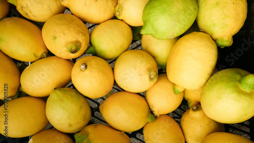 abstract background with close up of yellow lemons on market stall