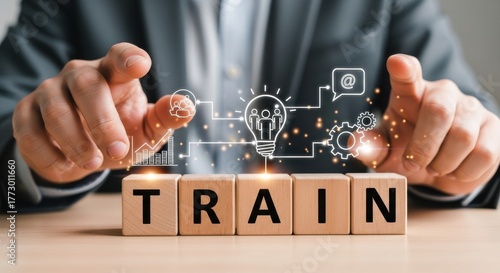 Hands of a business professional engaging in a training concept with graphical elements and wooden blocks spelling train