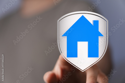 A hand points to a house ic...