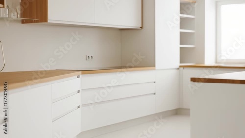 Wallpaper Mural This elegant kitchen showcases a modern design with sleek white cabinetry and warm wooden accents. The bright, open space is enhanced by natural light streaming through the window, creating an invitin Torontodigital.ca