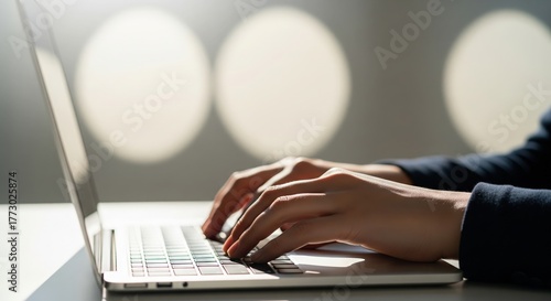 Hands Typing on Laptop in Bright Office