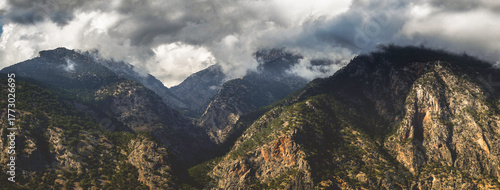Majestic mountains in the clouds. Panoramic landscape. Stormy weather, wilderness. 