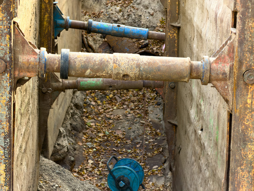 Valokuva Heavy-duty rusty metal trench shoring box components firmly reinforce the deep e